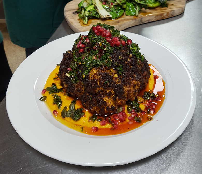 Spicy Vegan Roast Cauliflower on Butternut Squash Puree. Decorated with Chimichurri, Pomegranate Seeds and Toasted Pumpkin Seeds