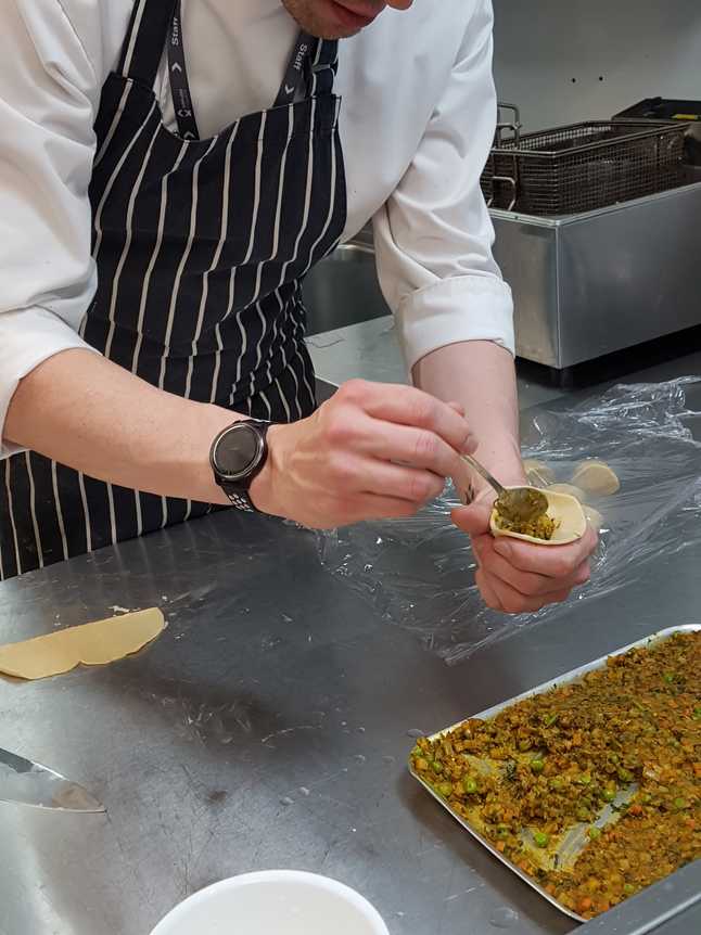 Aaron filling his Samosa