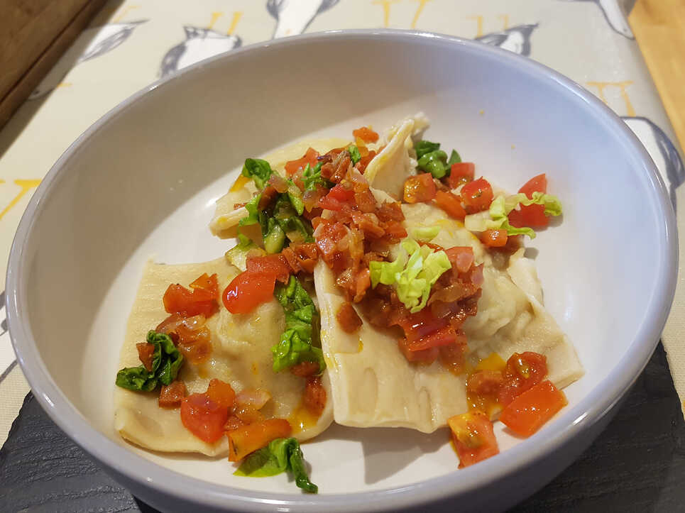 Karl's Crab Ravioli with Chorizo and Tomato Dressing.