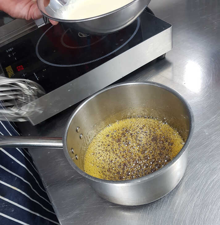 Aaron Preparing to add the cream to the boiling sugar.