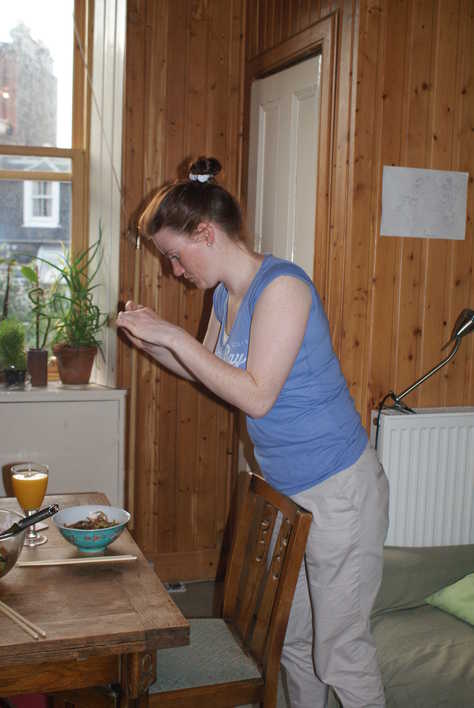 Flora photographing her duck chow mein.