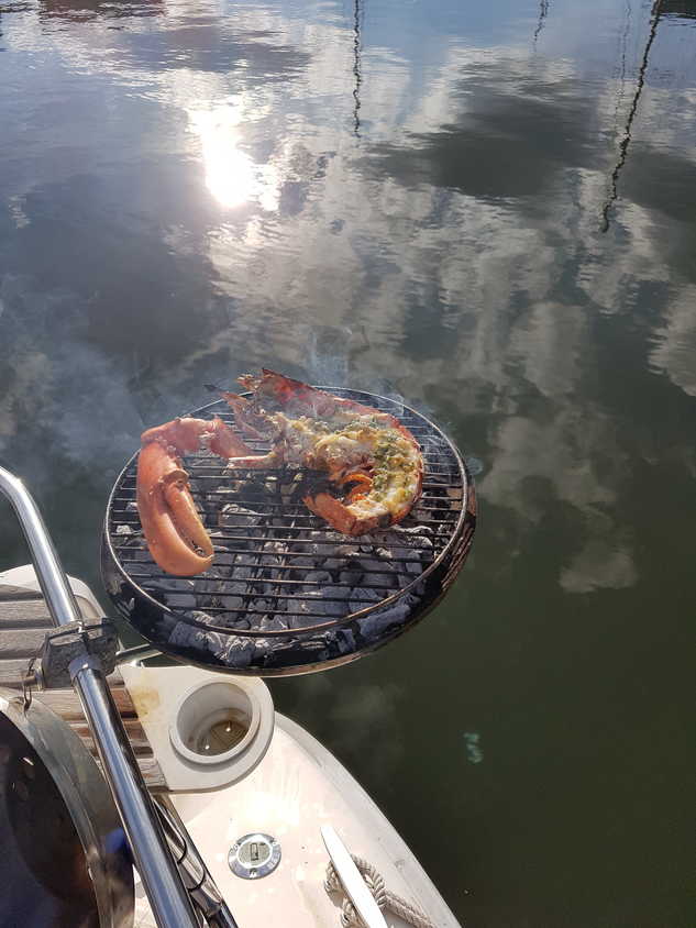 Grilling Lobster on a boat barbecue