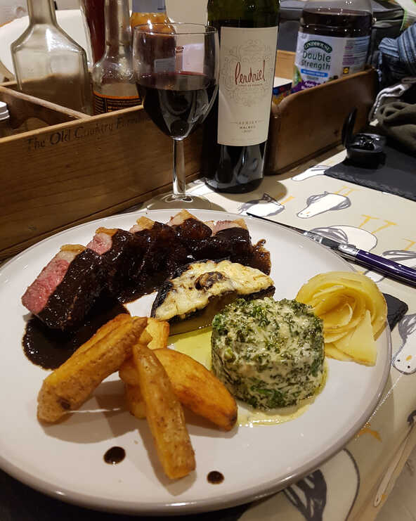 Red Wine, Redcurrant and Liquorice Sauce with Sirloin steak, Fat Chips, Half a Mushroom, Cheesy Kale and a Tête de Moine Rose.